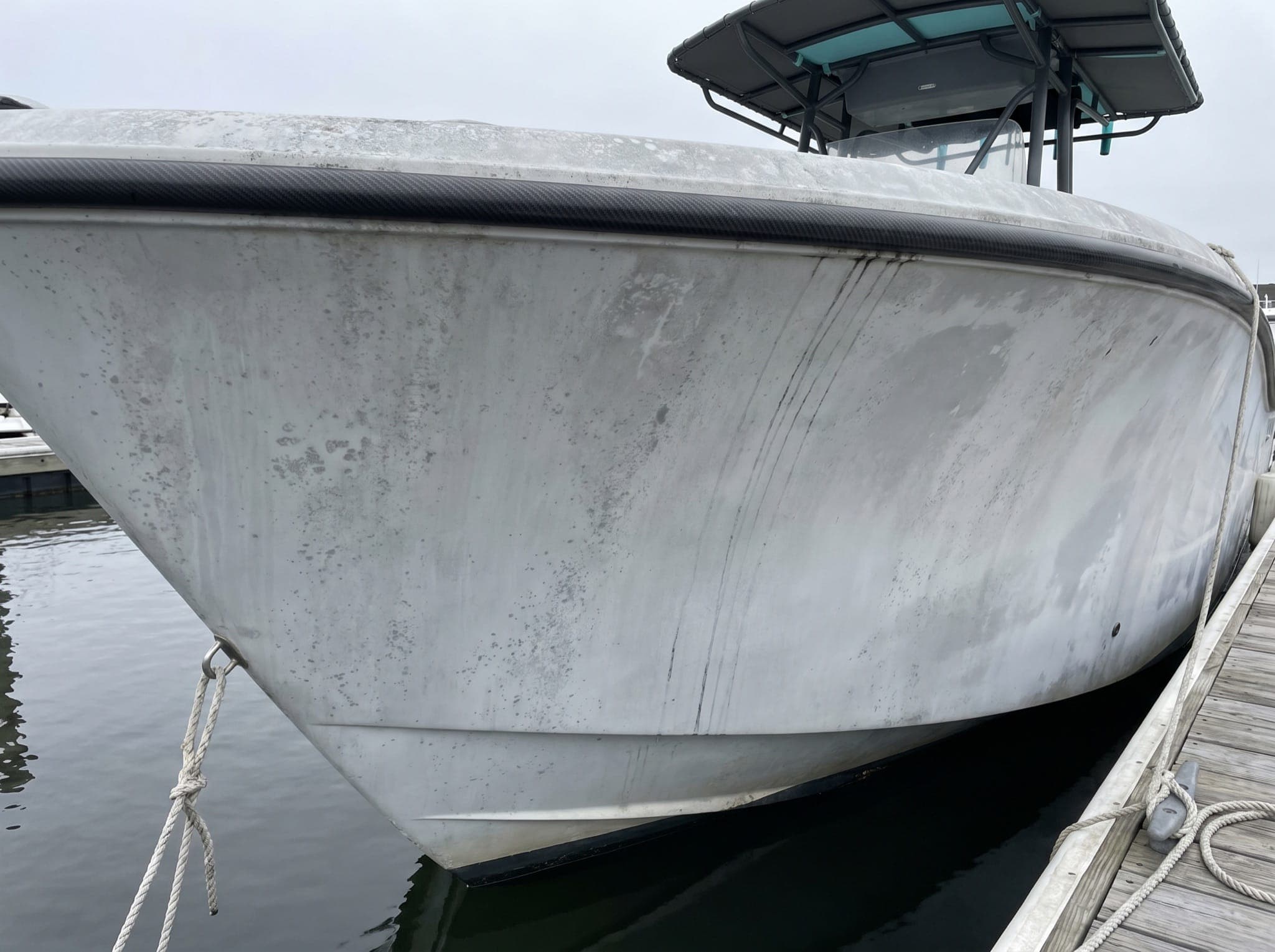 Dull, oxidized gelcoat with grime streaks before coating